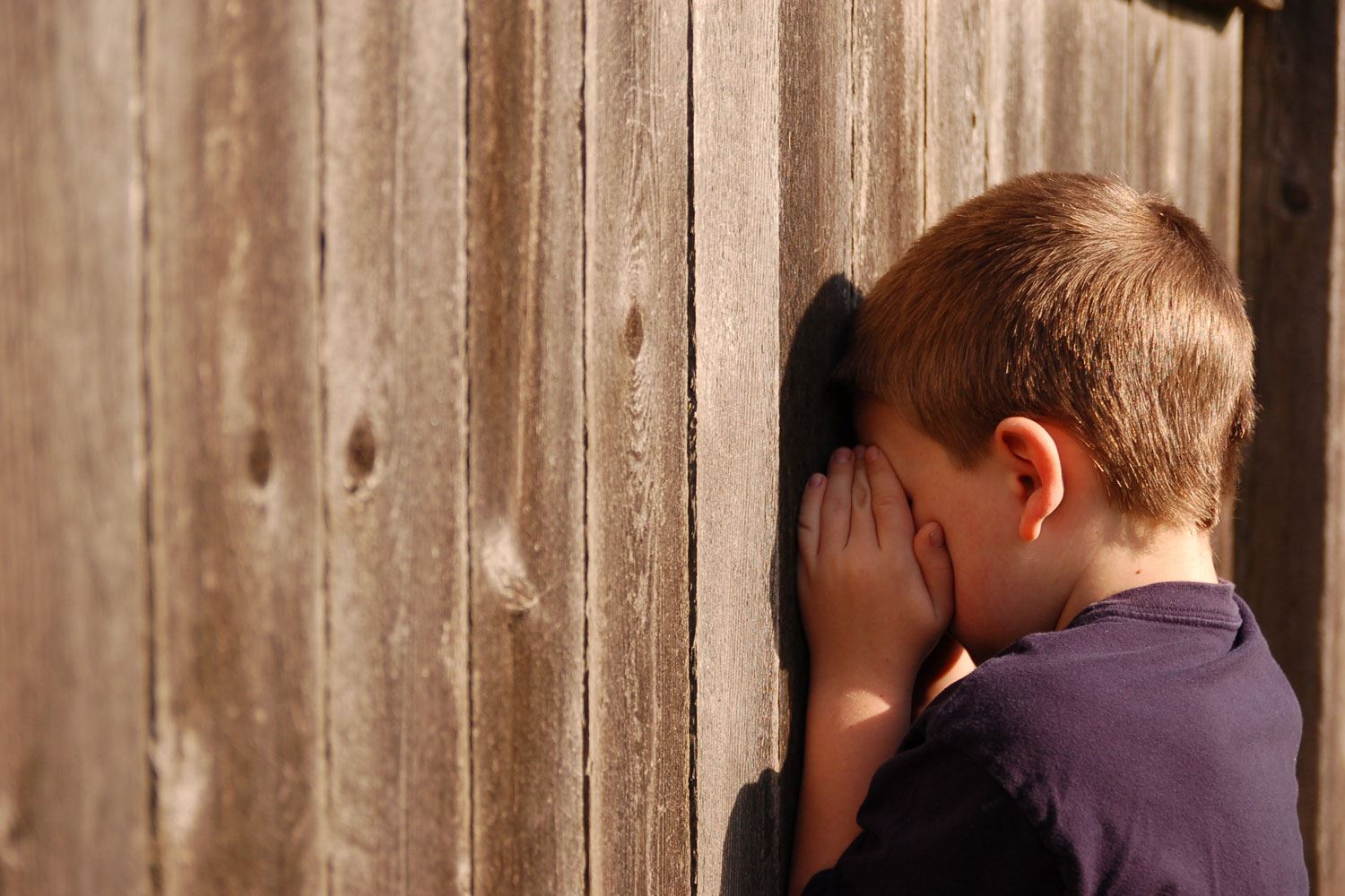 Boy covering his eyes