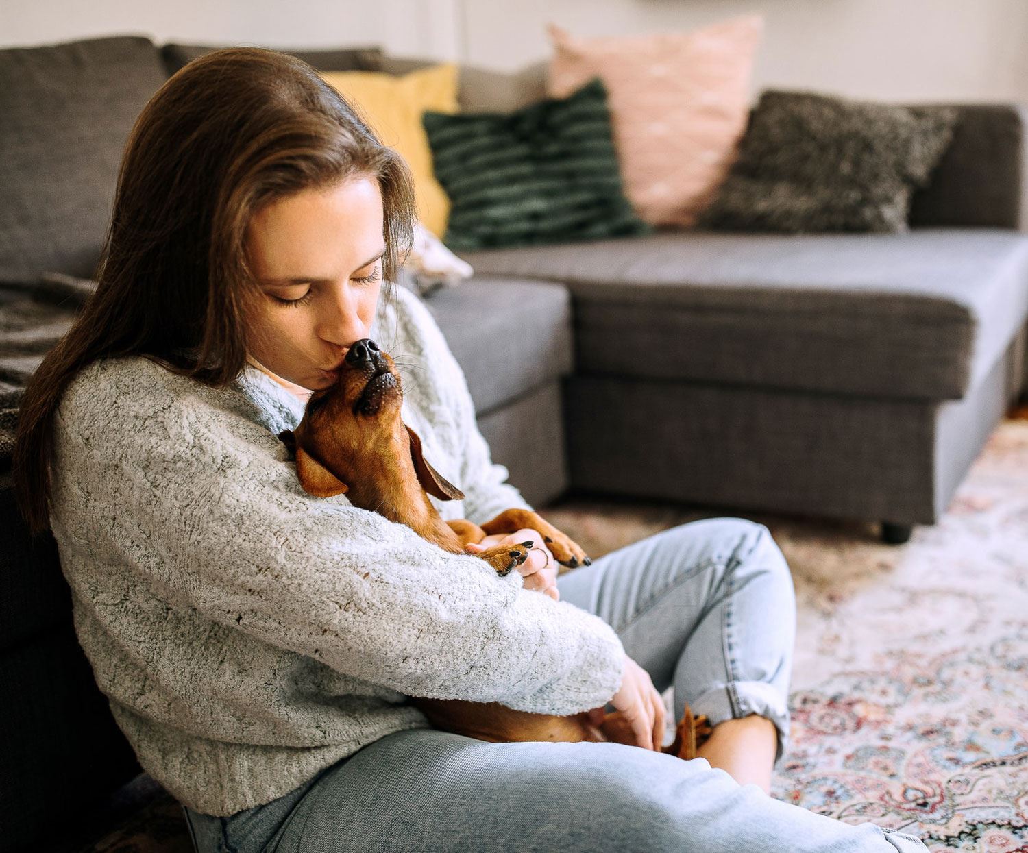 Woman kissing dog